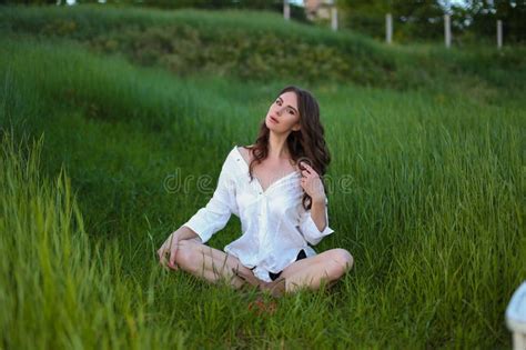 Beautiful Fashionable Brunette Woman Adult Posing In The Park On The Nature Backgraund In White