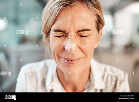 Dealing With A Bit Of Tension Shot Of A Mature Woman Closing Her Eyes In Pain Stock Photo Alamy