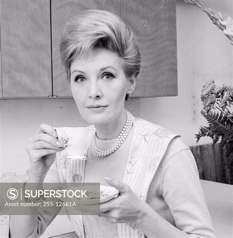 Portrait Of A Mature Woman Holding A Tea Cup Superstock