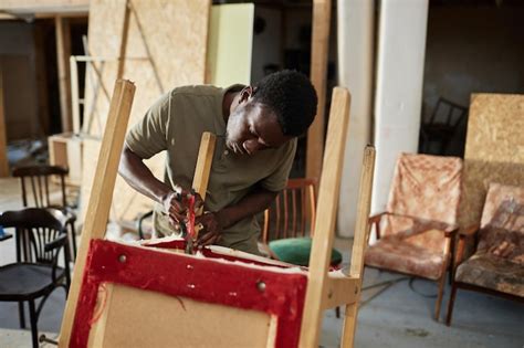 Premium Photo Black Man Repairing Furniture In Carpentry Workshop