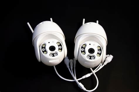 Premium Photo | Two white ip cameras placed on a black background