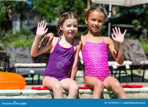 Girls In Swimsuits Waving Hands While Stock Image Image Of Cheerful Girlhood 197596515