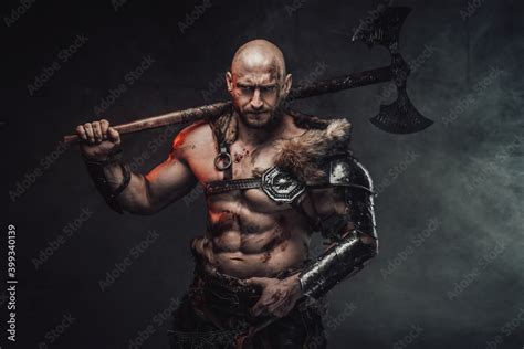 Violent Scandinavian Barbarian With Muscular Nude Build And Bald Head Posing In Dark Atmospheric