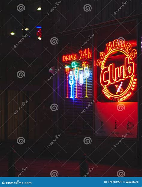 Vibrant Nightlife Scene Featuring a Club Illuminated by a Glowing Red
