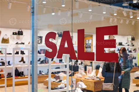 Sale in clothing store at shopping mall, seasonal promotions 12613754