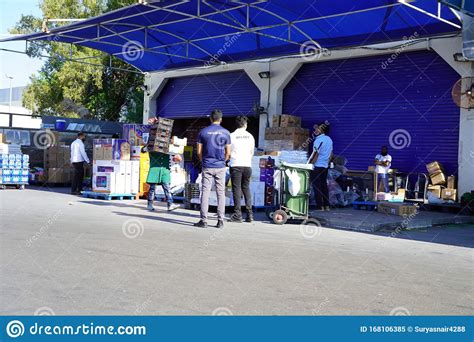 Workers With Manual Forklift And Boxes Stockpile Goods Near Storage