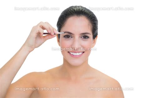 Smiling bare brunette using tweezers on white backgroundの写真素材 31702381