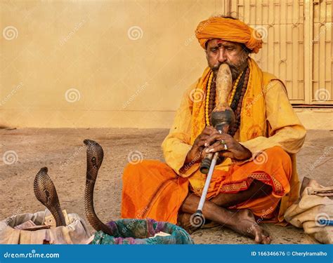 An Indian Snake Charmer and His King Cobra. Editorial Photo - Image of