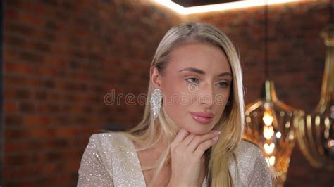 Close Up Portrait Of An Attractive Middle Aged Blonde In A Luxurious White Outfit Stock Footage