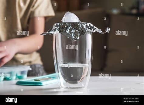 A Schoolgirl Conducts An Experiment With Hot Water And Ice Experience Getting Clouds In A Glass