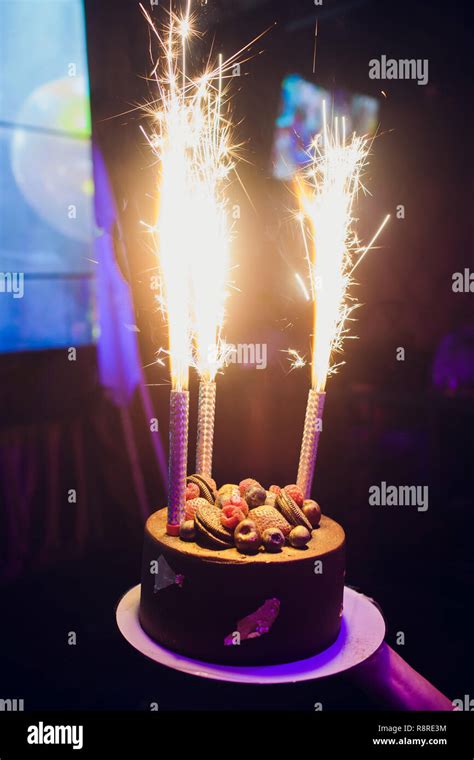 Birthday Cake With Fireworks On Table Stock Photo Alamy