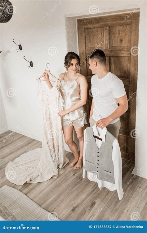 Smiling Brunette Bride In A White Coat And Lingerie The Morning Of The Bride Stock Image