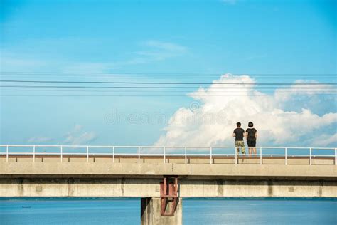 Man And Woman Standing On The Bridge With Blue Sky Background Editorial
