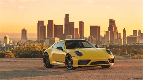 yellow porsche  parked  asphalt road  city buildings