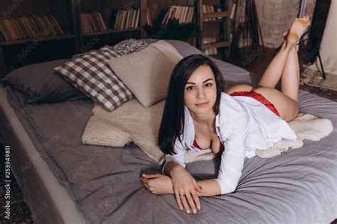 Sexy Lady In Lace Lingerie With Long Black Hair Looking At Camera And Lying In Bedroom In Big