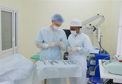 The Surgeon Together With The Assistant Assistant Prepare For The Operation By Preparing