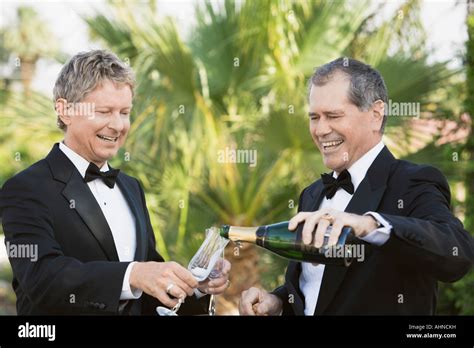 Newlywed Gay Couple Pouring Themselves Champagne Stock Photo Alamy