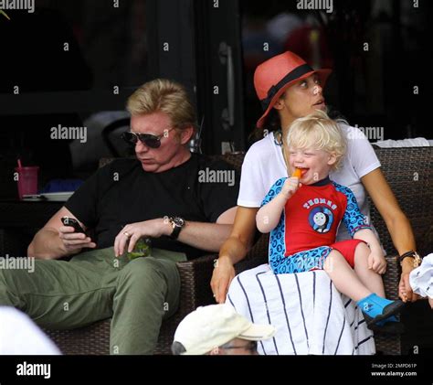 The Becker family lunch at a beachside hotel pool with pals. Boris and ...