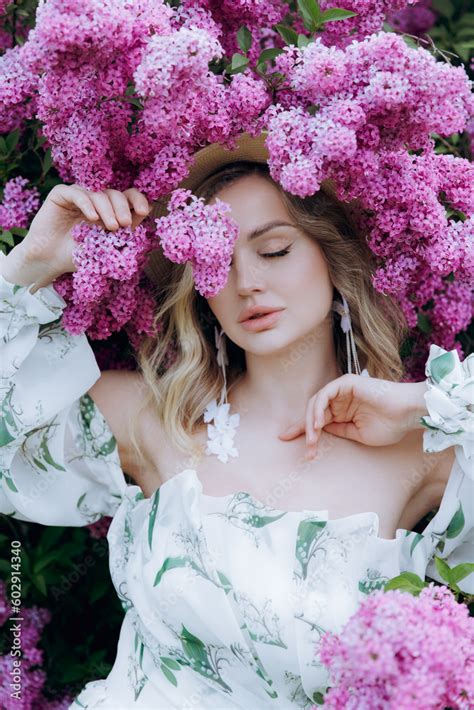 Beautiful Stylish Cute Blonde In A White Dress With A Green Pattern As A Model For A Photo