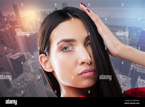 Attractive Brunette Touching Her Hair Stock Photo Alamy