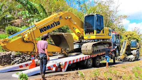 Excavator Transport To The Construction Site By Self Loader Truck Cat