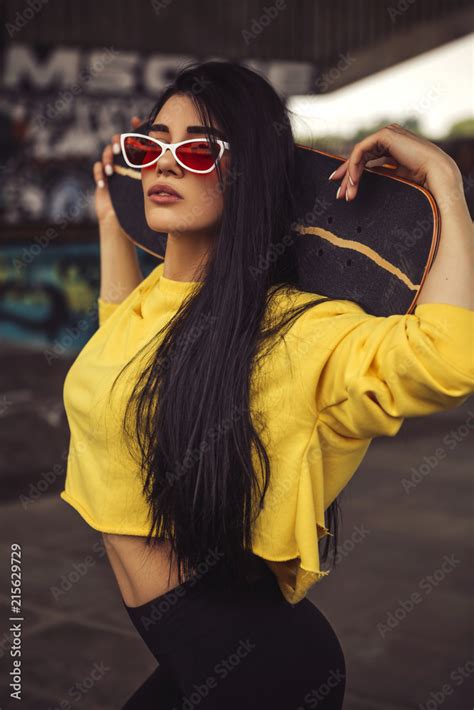 Sexy Slim Fit Brunette Woman In Sport Casual Outfit In A Skate Park Active Leisure On A