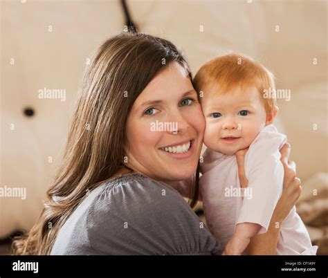 Caucasian Mother Holding Baby Daughter Stock Photo Alamy