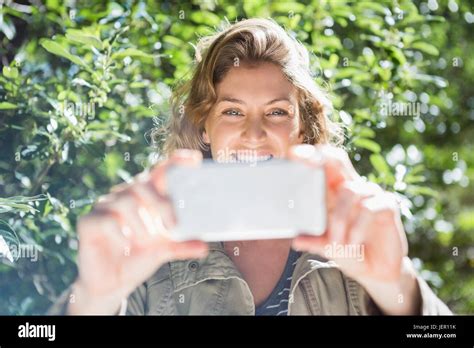 Smiling Woman Taking Selfies Stock Photo Alamy