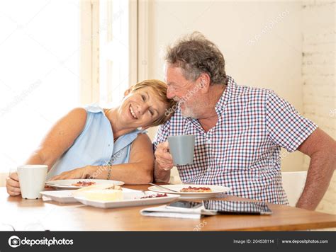 Attractive Mature Retired Couple Having Breakfast Together Home Stock Photo Sbartsmediagmail