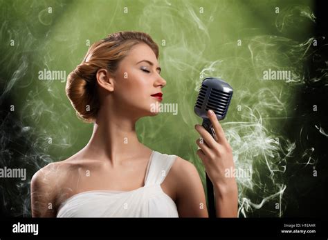 Beautiful Blonde Woman Singer With A Microphone Stock Photo Alamy