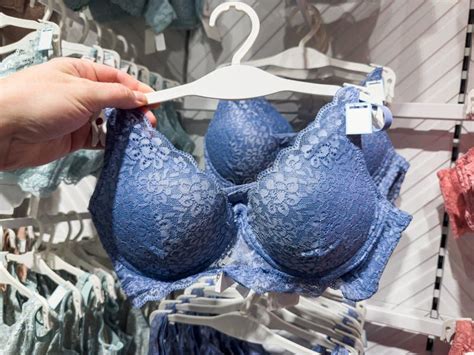 Woman Chooses Blue Lace Bra On Rack In Lingerie Store Female Fashion Underwear Stock Photo