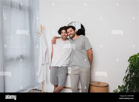 Smiling Gay Man Hugging Pleased Boyfriend In Bathroom Stock Photo Alamy