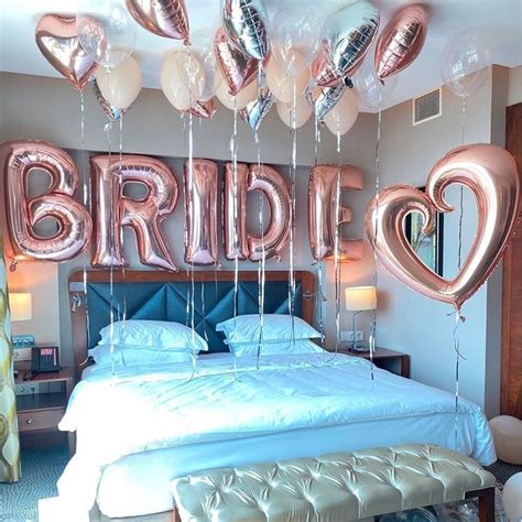 A Bed With Balloons That Spell Out The Word Bride On It And Heart