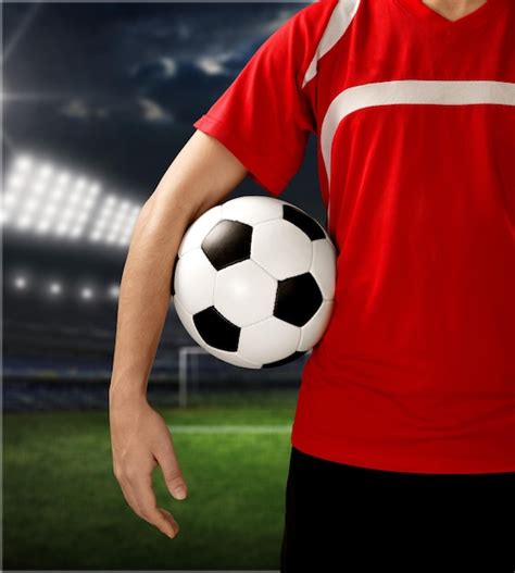 premium photo midsection   soccer player holding  ball