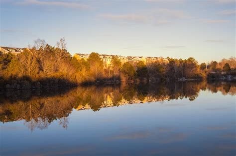 Premium Photo | Houses by the cary lake park on a winter day sunset