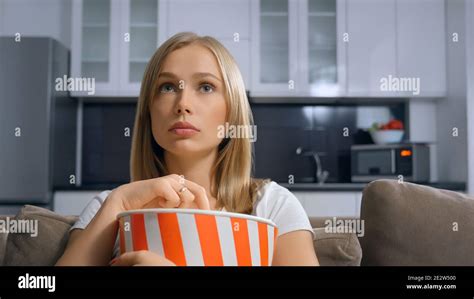 Beautiful Blonde Enjoying Popcorn And Movie Concept Of Watching Film With Tasty Food On The