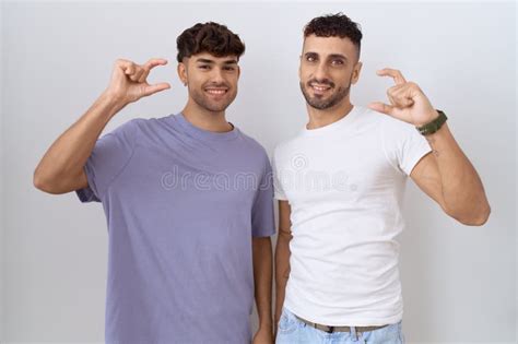 Homosexual Gay Couple Standing Over White Background Smiling And Confident Gesturing With Hand