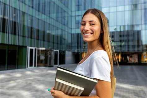 Happy Smiling Blonde Female College Student Looking At Camera Holding Notebooks Copy Space