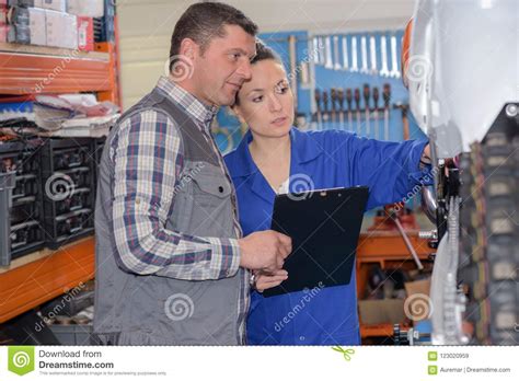 Mechanic And Cowoker Assessing Car Stock Image Image Of File