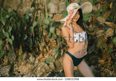 Sexy Asia Woman In Green Bikini On The Beach