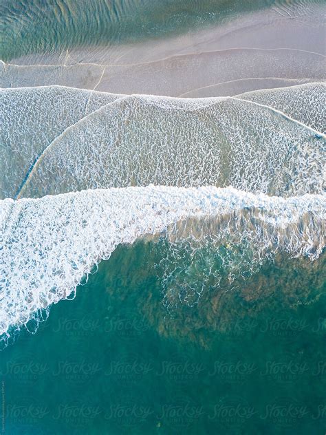 Aerial View Of Waves Crashing On A Beach By Stocksy Contributor