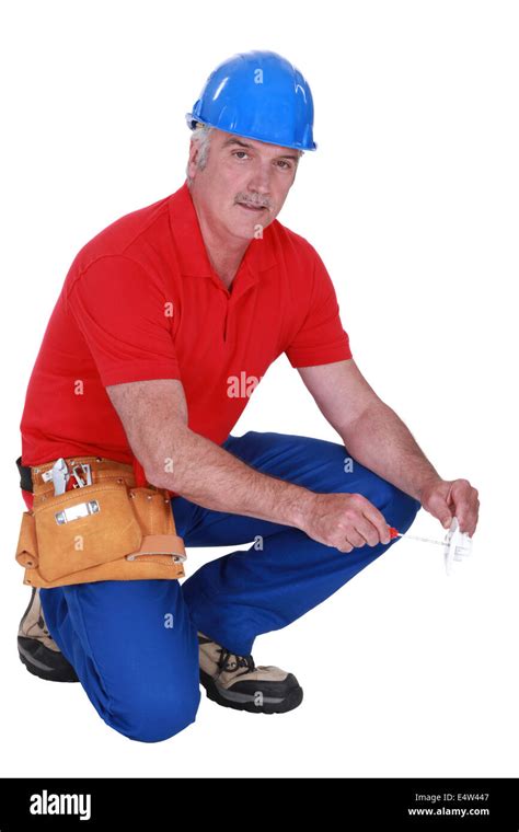 Mature Craftsman Squatting Stock Photo Alamy