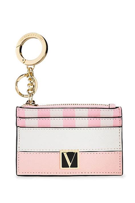 A Pink And White Card Case With A Keychain Hanging From The Front