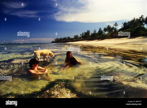Tourists Relaxing In Shallow Water In Tiwi Beach Kenya Stock Photo Alamy