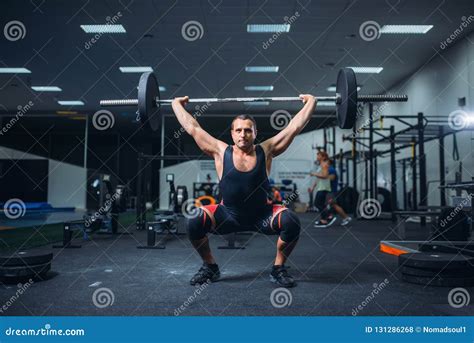 Powerlifter Doing Weightlifting Exercise Man With Naked Torso Lifting Weights Stock Photography