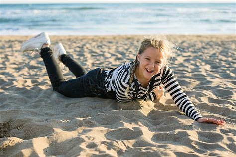 Portrait Of A Blonde Girl Having Fun On The Beach In Autumn By Stocksy Contributor