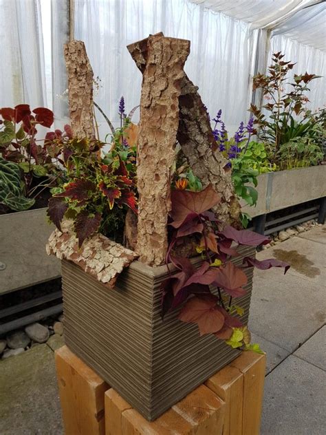 A Wooden Planter Filled With Lots Of Plants