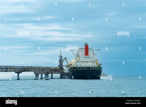 Liquefied Natural Gas Carrier Tanker During Loading At An Lng Offshore Terminal In The Distance