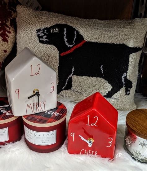 A Red Clock Sitting On Top Of A White Fur Covered Floor Next To Some