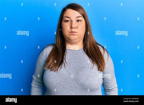 Beautiful Brunette Plus Size Woman Wearing Casual Clothes Puffing Cheeks With Funny Face Mouth